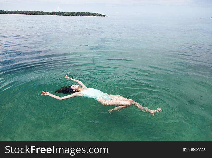 Photography of a Woman Floating on Water