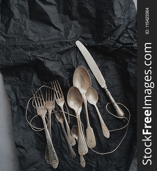 Photo of Stainless Steel Cutlery on Black Cloth