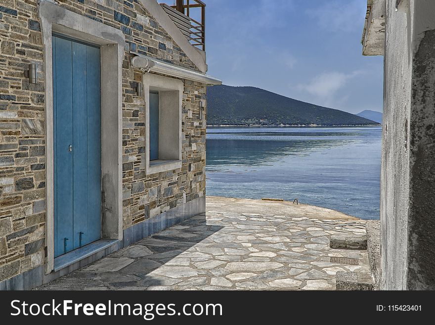 Gray Concrete Houses Near Body Of Water