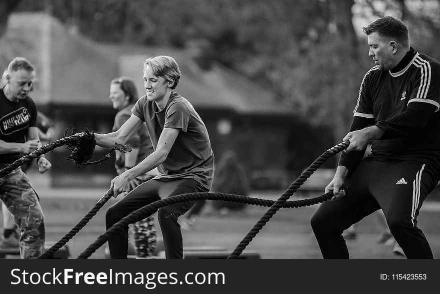 Grayscale Photography of Two Men Using Exercise Ropes