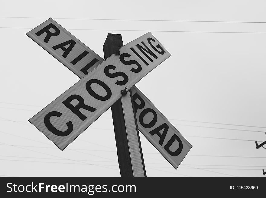 Grayscale Photography of Railroad Crossing Signage