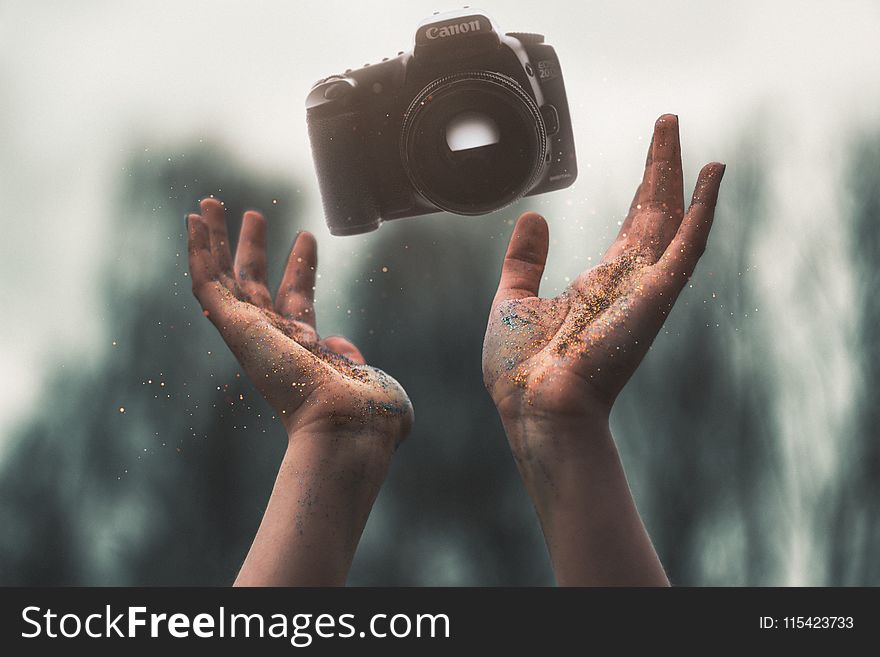 Selevtice Photography of Black Canon Dslr Camera Above Human Hands