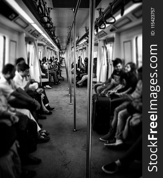 Grayscale Photography of Train Passengers