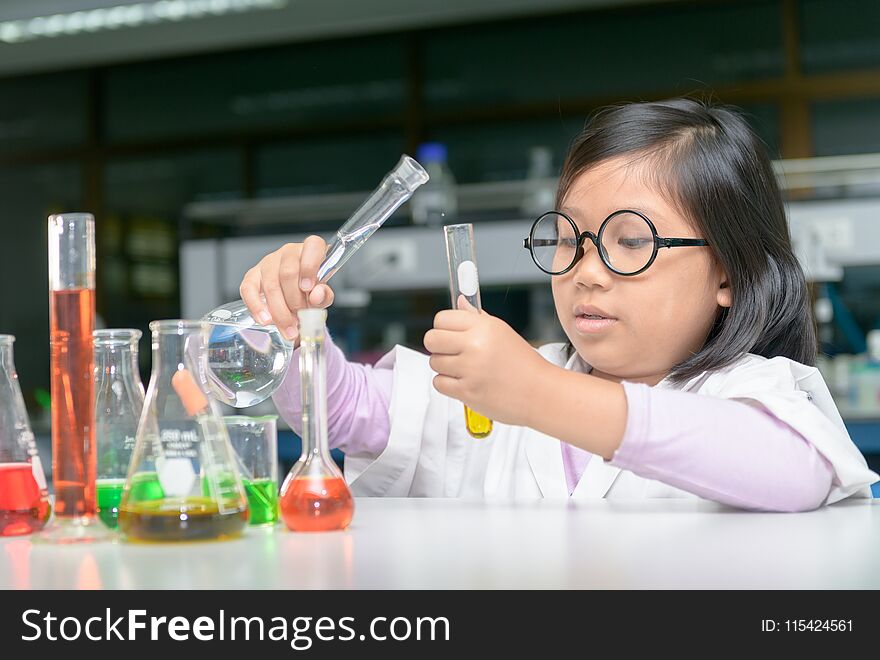 Scientist girl making experiment with test tube