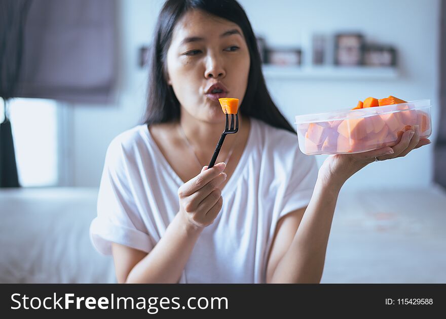 Young asian woman eating fresh fruits papaya slices,Concept healthy food