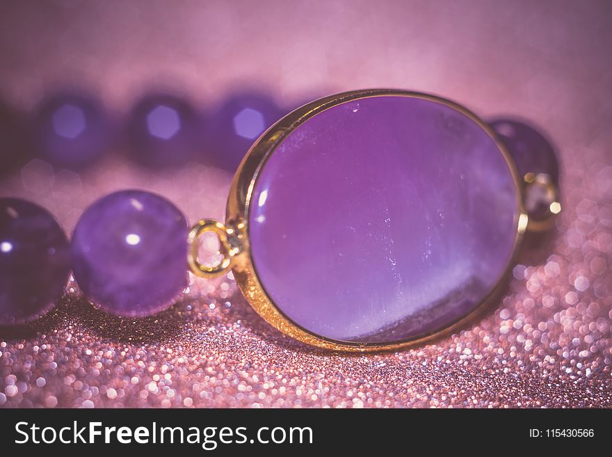 Fashion bracelet made of natural purple amethyst beads, filtered background. Fashion bracelet made of natural purple amethyst beads, filtered background.