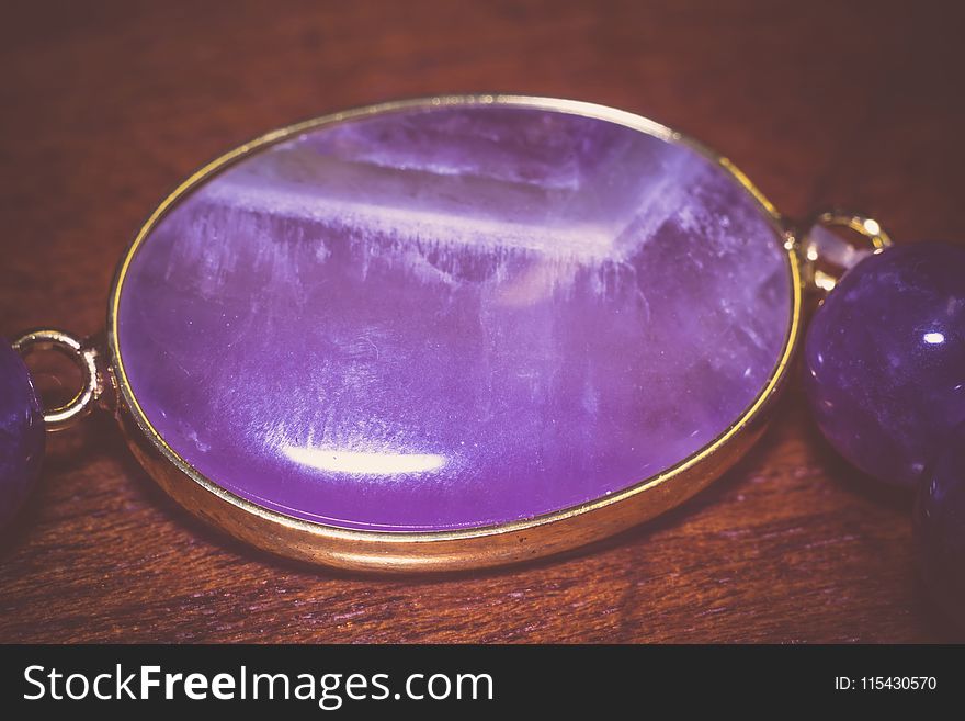 Fashion bracelet made of natural purple amethyst beads, filtered background. Fashion bracelet made of natural purple amethyst beads, filtered background.