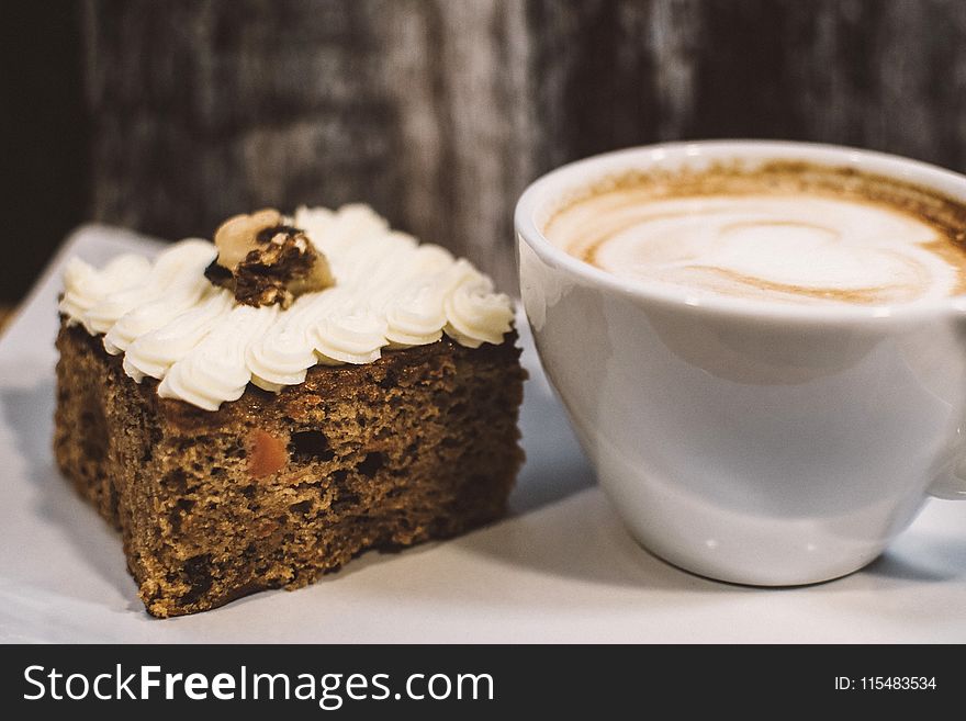 White Ceramic Teacup Near Baked Bread