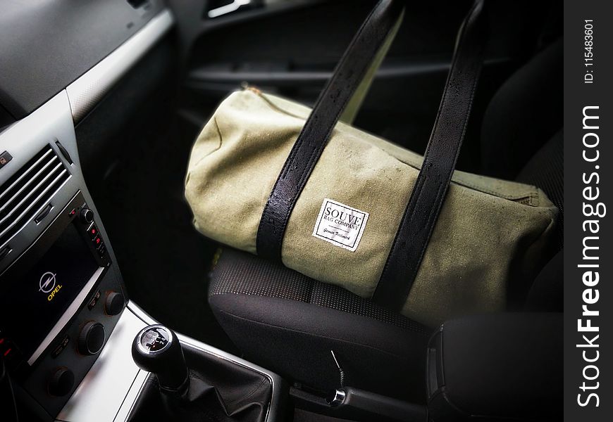 Brown and Black Duffel Bag on a Car Seat