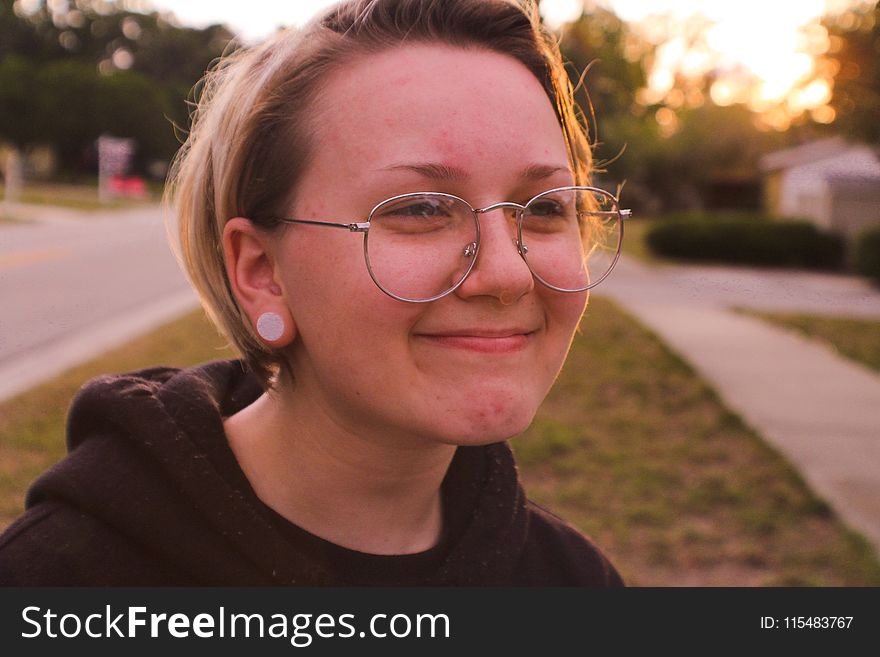 Woman Wearing Black Pullover Hoodie And Round Silver-colored Eyeglasses Smiling