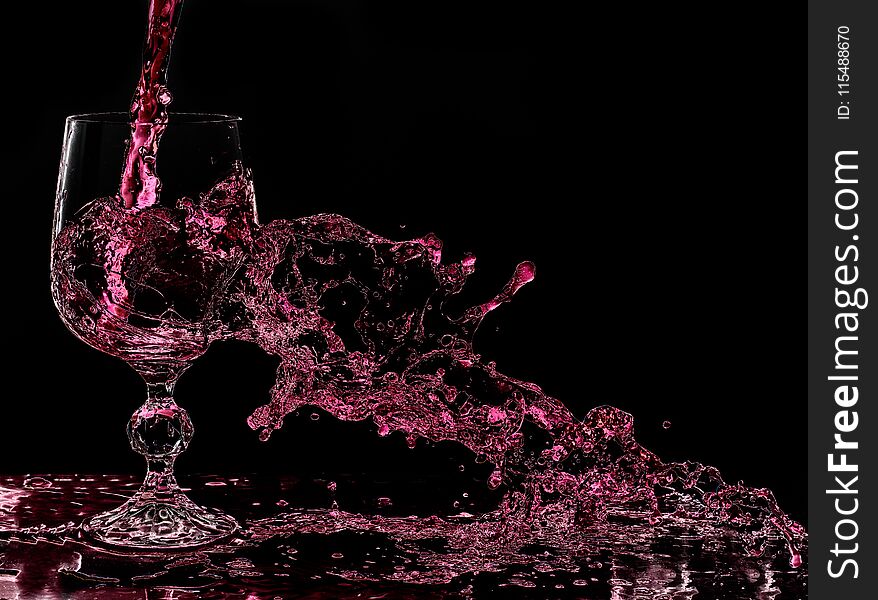 Wine splashes out of glass when poured. Wine splashes out of glass when poured