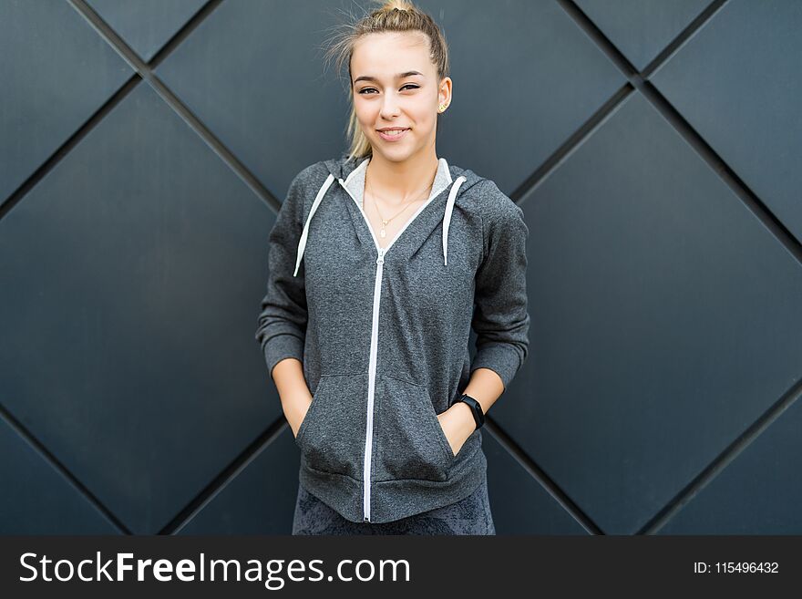 Portrait of young beautiful fitness woman, isolated on black background outdoors in the city space