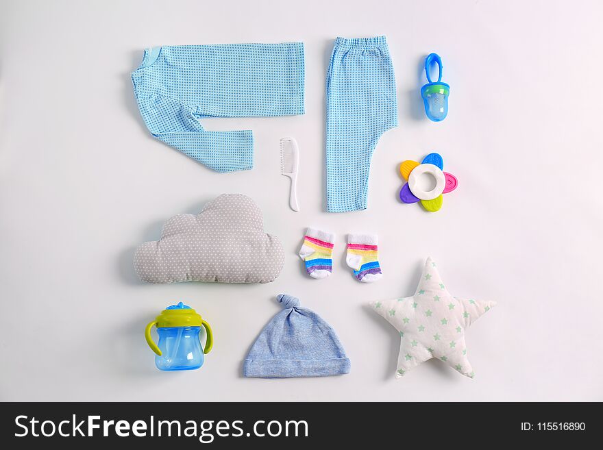 Set of baby clothes and accessories on light background, flat lay