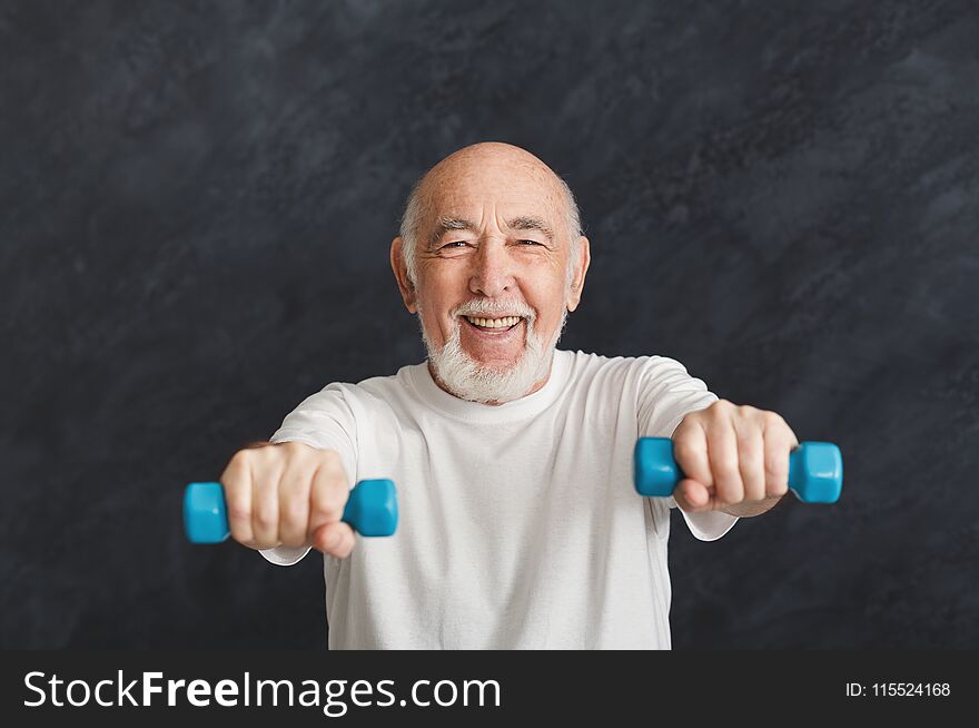 Senior man making exercise with dumbbells