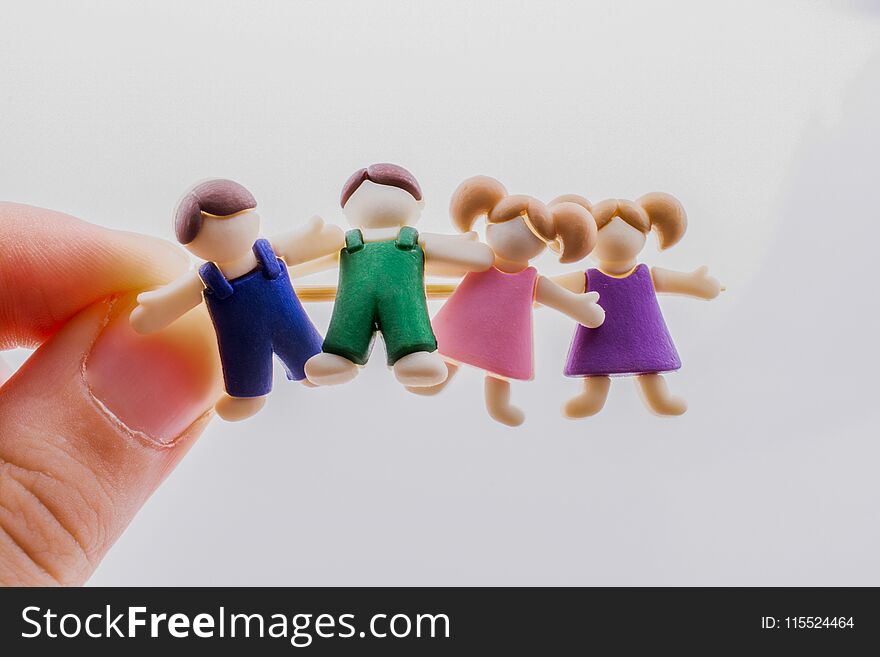 Little colorful boys and girls kid figurines in hand. Little colorful boys and girls kid figurines in hand