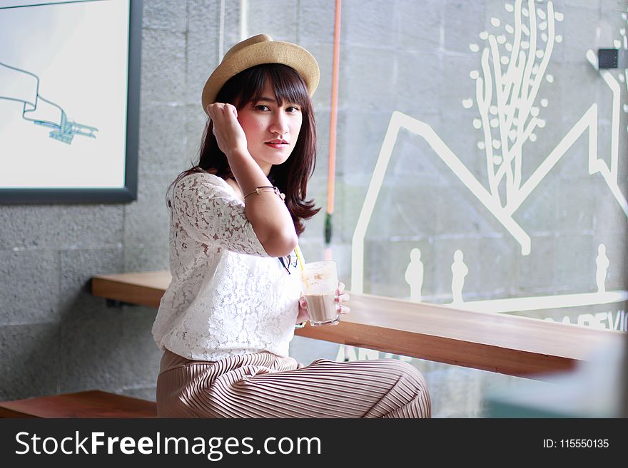 Photography of a Woman Sitting on Bench