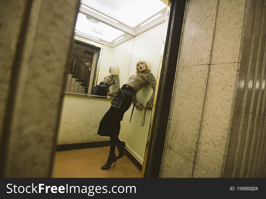 Photography of a Woman on Elevator