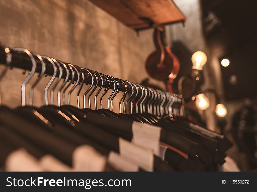 Photo of Black Clothes on Hangers