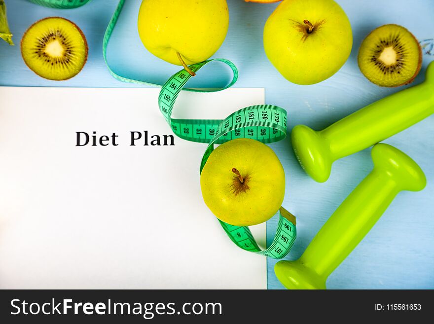 Food and sheet of paper with a diet plan on a blue wooden background. Concept of diet and healthy lifestyle.