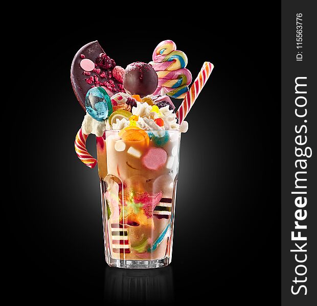 Monster shake, freak caramel shake. Colourful, festive milk shake cocktail with sweets, candy, jelly. Colored caramel milkshakes array of different childs sweets and treats in glass on white background. Sweet candy milkshake. Crazy freakshake food trend isolated. Monster shake, freak caramel shake. Colourful, festive milk shake cocktail with sweets, candy, jelly. Colored caramel milkshakes array of different childs sweets and treats in glass on white background. Sweet candy milkshake. Crazy freakshake food trend isolated.