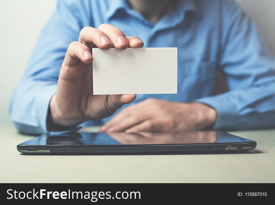 Businessman Showing A Business Card In His Business Desk.