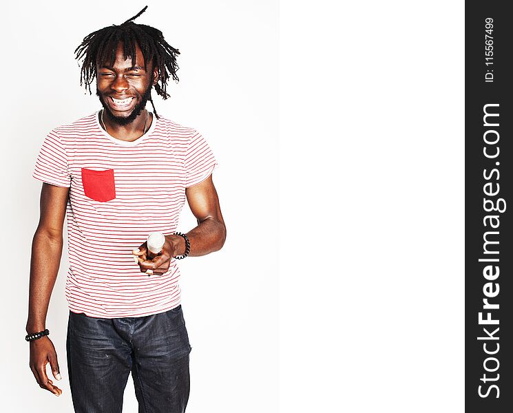 Young handsome african american boy singing emotional with microphone isolated on white background, in motion gesturing smiling, lifestyle people concept close up