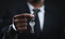 Asian Businessman Holding Keys Royalty Free Stock Image