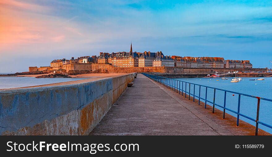 Panoramic view of walled city Saint-Malo with St Vincent Cathedral at sunset. Saint-Maol is famous port city of Privateers is known as city corsaire, Brittany, France. Panoramic view of walled city Saint-Malo with St Vincent Cathedral at sunset. Saint-Maol is famous port city of Privateers is known as city corsaire, Brittany, France