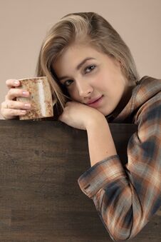 Young Pretty Blonde Woman In Brown Plaid Shirt With Coffee Mug Royalty Free Stock Images Young Pretty Blonde Woman In Brown Plaid Shirt With Coffee Mug Royalty Free Stock Images