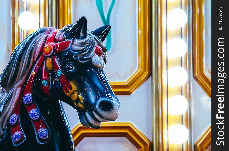 Colorful Horse carousel in Luna Park. Horse merry-go-round, vintage childhood background.