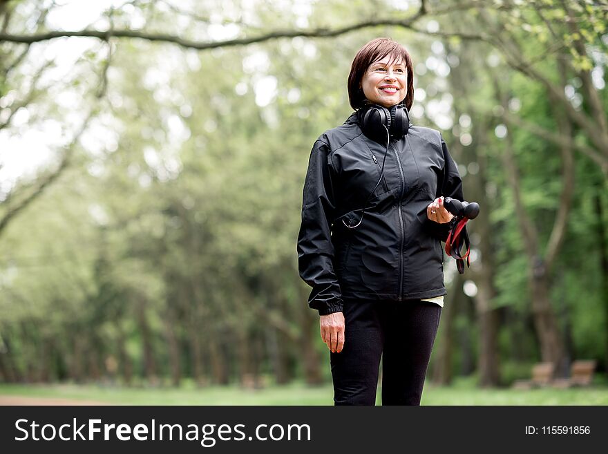 Woman Walking With Hiking Sticks