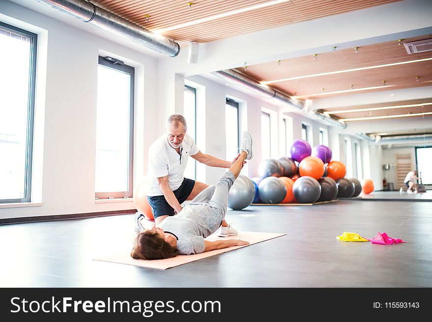 Senior Physiotherapist Working With A Female Patient.