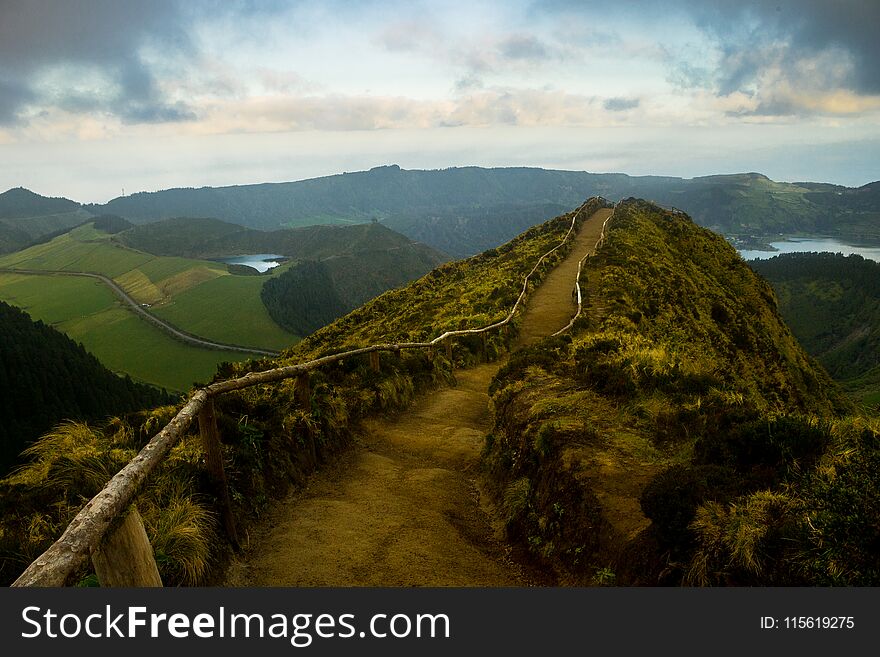 A path leads to a view above various volcano-shaped lakes at the SÃ£o Miguel Island, in Azores. A path leads to a view above various volcano-shaped lakes at the SÃ£o Miguel Island, in Azores.