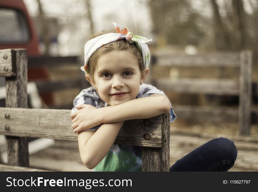 Young girl in a wood truck bed