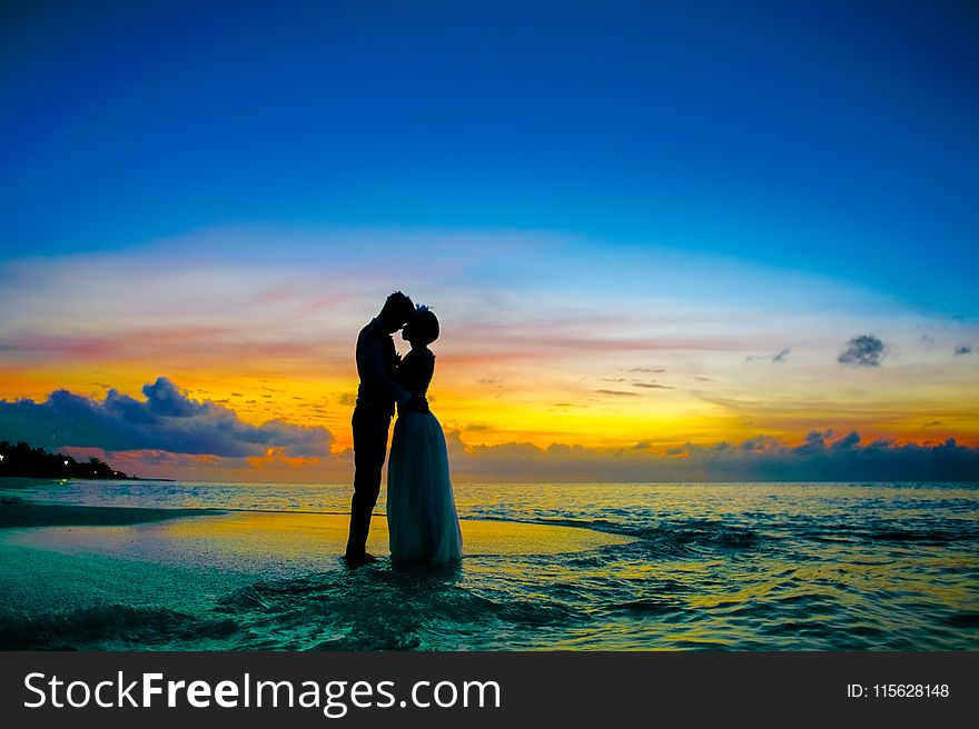 Man and Woman Standing at Seashore