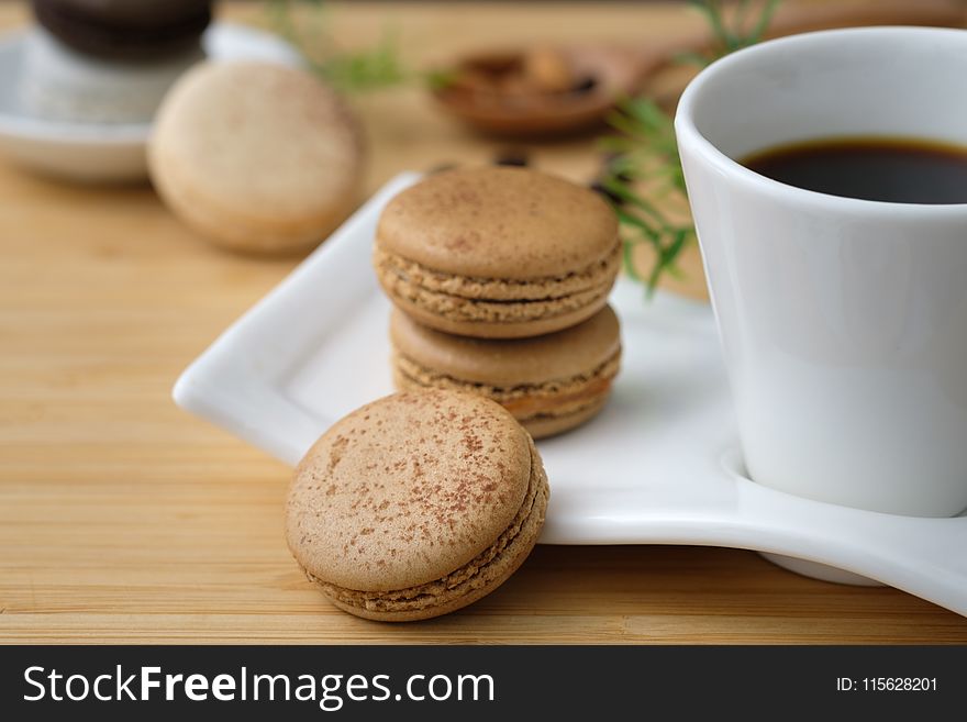 Three Cookies Beside Cup of Coffee