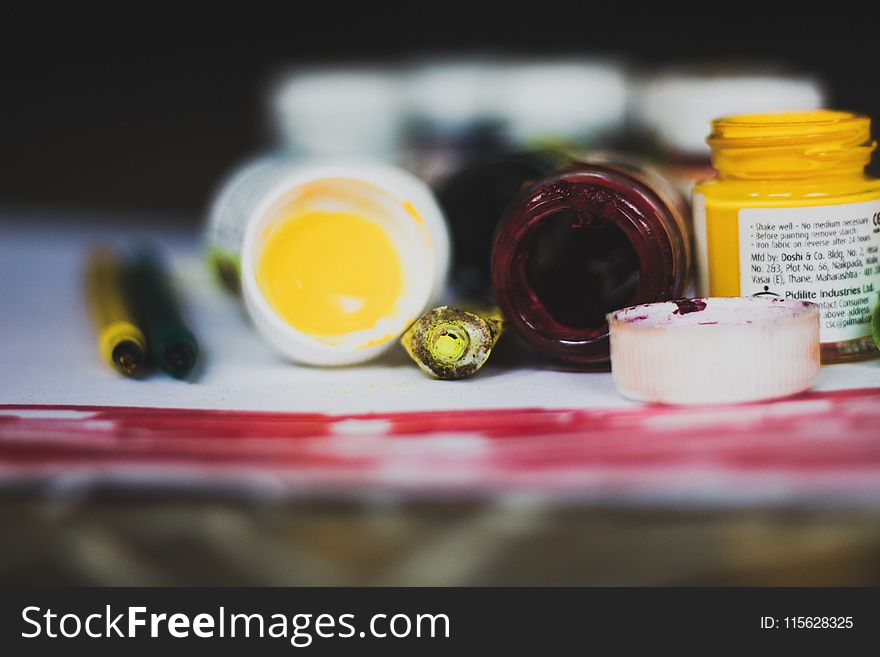 Selective Focus Photo of Opened Paint Containers