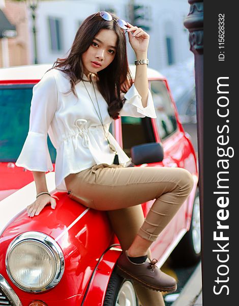 Photography of a Woman Leaning on the Car