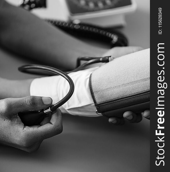 Greyscale Photo of Person Taking Blood Pressure