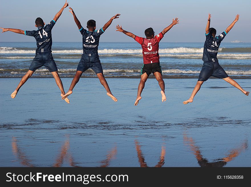 Photo Of Four Men On Water