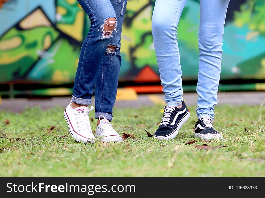 Person&#x27;s Wearing White and Black Low-top Sneakers