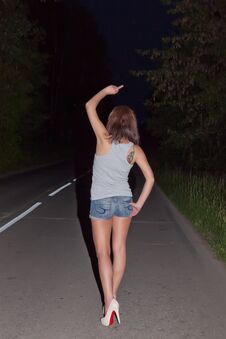 Girl Showing Obscene Gestures At Walking Distance Along Road Stock Images