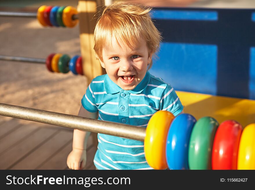 Cute little boy at playground area. Summer outdoor