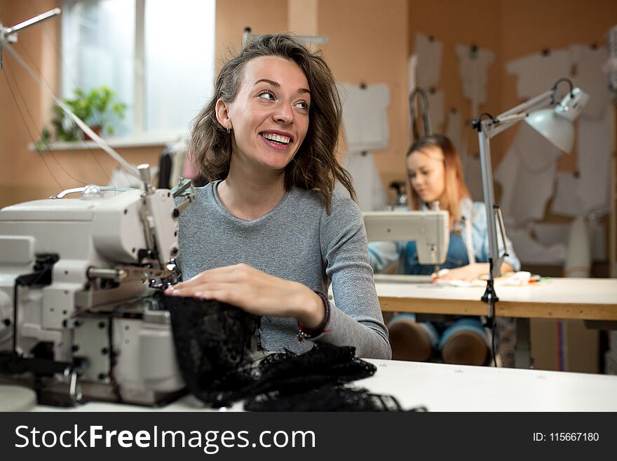 Women seamstresses work in the workshop on sewing machines