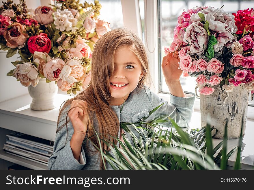 A girl with the colorful flower bouquet.