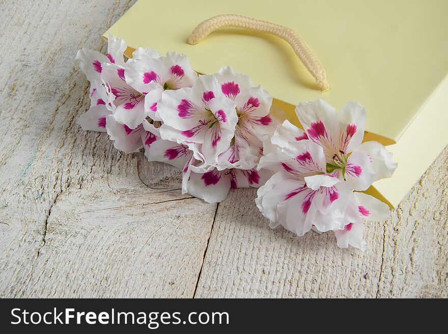 Beautiful fresh flowers in the paper bag - decoration, gift concept. Space for text