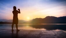Man Traveler Taking Photos Of Sunset At Mountain And River Lands Royalty Free Stock Photos Man Traveler Taking Photos Of Sunset At Mountain And River Lands Royalty Free Stock Photos