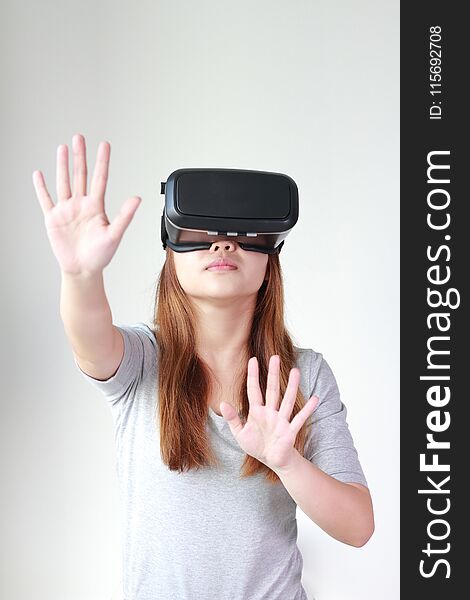 Young woman wearing virtual reality glasses at home.