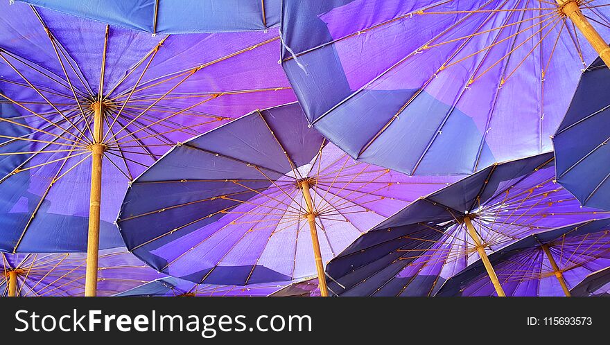 Looking up at a violet parasol, big umbrellas at the Cha am beach, Thailand. Looking up at a violet parasol, big umbrellas at the Cha am beach, Thailand