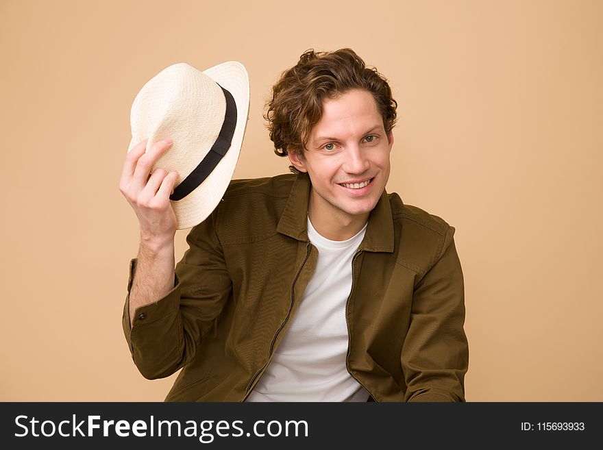Man Wearing Brown Dress Shirt Holding White Fedora Hat